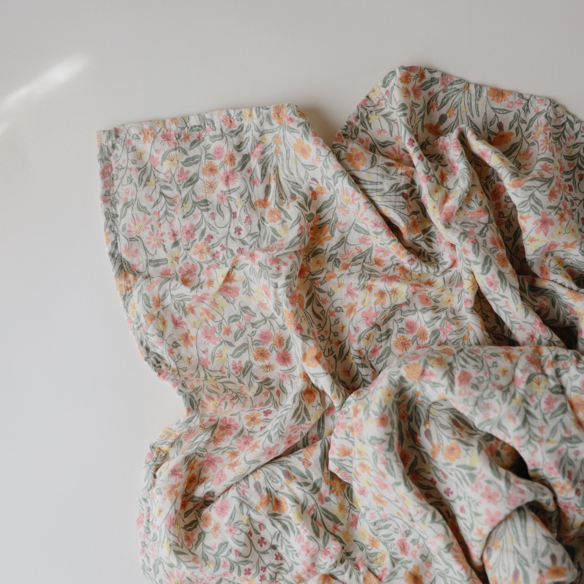 Lifestyle image of Organic Cotton Swaddle in Pastel Blooms