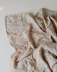 Lifestyle image of Organic Cotton Swaddle in Pastel Blooms