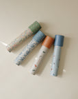 Four mushie Kaleidoscopes with patterned tubes and bright caps, perfect for kids’ play.