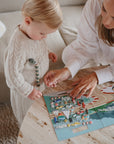 mom and child with sticker book cars