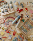 Mushie Kaleidoscopes inspire imaginative play on a light surface.