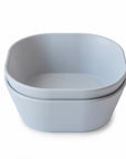 Two stacked, light gray Square Dinnerware Bowls by mushie, featuring rounded edges and made from BPA-free plastic, are shown on a white background.