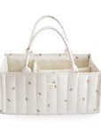 Mushie Diaper Caddy: cream quilted, floral print, interior compartments, top view.