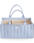 Mushie Diaper Caddy in Tradewinds, quilted fabric with handles and beige compartments.