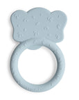 The mushie Elephant Teether is a light blue silicone baby teether shaped like an elephant’s head, featuring textured details, a circular grip at the bottom, and "mushie" embossed on the ring.