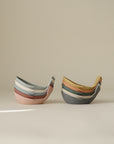 Mushie Whale Bath Stackers in pastel colors, shown stacked on a neutral background.
