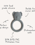 The mushie Koala Teether is a gray, koala-shaped silicone teether with a circular grip. Made from 100% food-grade, non-toxic silicone, it’s dishwasher safe and BPA/BPS/PVC/phthalate-free—perfect for building fine motor skills.