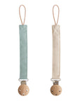 Mushie Linen Pacifier Clip 2-Pack with wooden clasps in light blue and beige on white background.