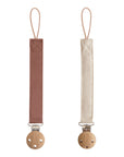 Mushie Linen Pacifier Clip 2-Pack: brown & beige clips with wooden clasps on white background.