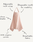 The mushie Muslin Nursing Cover in light pink is made from 100% organic cotton, doubles as a breathable apron, and features a shapeable neckline, adjustable neck strap, pointed hem, and is machine washable.