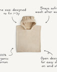 The mushie Bear Poncho Towel is a beige hooded towel with bear ears, made from 100% organic cotton. One size fits ages 1–3, featuring an open poncho design for easy on/off and stays soft after every wash.