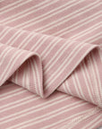 Closeup of Rylee + Cru Ribbed Long Sleeve Dress in dusty rose microstripe with white stripes.