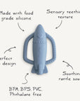 The mushie Rocket Rattle Teether is a blue, food-grade silicone baby teether with sensory texture, easy-grip design, soothing rattle sound, and is BPA/BPS/PVC/Phthalate free—an ideal choice for teething infants.