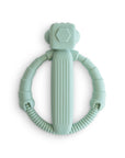 The mushie Robot Rattle Teether is a mint green, ring-shaped silicone baby teether with a ribbed handle and flexible, segmented sides, shown here on a white background.
