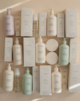 Mushie Baby Body Lotion with natural ingredients displayed in assorted bottles and boxes.
