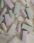 Mushie Baby Body Lotion with natural ingredients on a light surface.