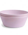 A stack of two light pink mushie Round Dinnerware Bowls, made from BPA-free material, is displayed on a white background.