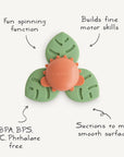 The mushie Suction Spinner Toy is made of BPA-, BPS-, PVC-, and phthalate-free food-grade silicone, has three green and orange leaf-shaped arms, suctions to smooth surfaces, offers sensory fun, and helps build fine motor skills.