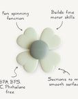The mushie Suction Spinner Toy is a flower-shaped silicone spinner with a gray center and white petals. It suctions to most smooth surfaces, spins for sensory fun, builds fine motor skills, and is BPA, BPS, PVC & Phthalate free.