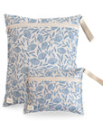 Two fabric pouches with white zippers and handles, featuring a blue flowers print on white. The mushie Water Resistant Wet Bags are shown against a white backdrop, the larger pouch behind the smaller—ideal for diaper bag storage.