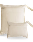Two fog-colored, rectangular mushie Water Resistant Wet Bags with zippers and fabric loop handles—one large, one small—are shown. Both have a subtle logo tag in the corner and are perfect for diaper bag storage or organizing wet items.
