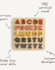 The Mushie Wooden Puzzle is a colorful square board alphabet toy made from FSC certified wood with non-toxic paint, designed to support language development and fine motor skills in little learners.