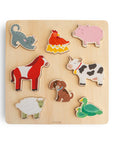 The Mushie Wooden Puzzle features seven colorful animal pieces on a light wood board, fostering fine motor skills and playful animal recognition for children.