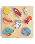 The Mushie Wooden Puzzle features colorful, cartoon-faced pieces shaped like the sun, rocket, and moon—an educational toy designed to help kids build fine motor skills through fun and interactive play.