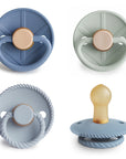 FRIGG Natural Rubber Pacifier 4-Pack in blue, green, and light gray with varied textures.