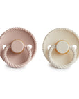 Mushie FRIGG Rope Natural Rubber Pacifier 2-Pack in pink and cream on a white background.