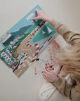 child with sticker book cars