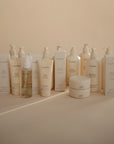Mushie Baby Body Lotion with natural ingredients, arranged in rows with neutral tones.
