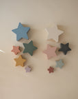 Mushie Nesting Stars Toy arranged on a light surface, perfect for fine motor skill play.