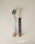 Mushie Linen Pacifier Clip 2-Pack: blue and white clips with fabric straps and wooden clasps.