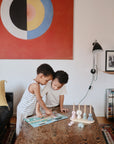 small kids playing with sticker books
