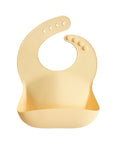 Mushie Silicone Baby Bib: easy-clean, adjustable fit, with crumb catcher pocket.