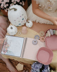 Kids use mushie’s Reusable Water Color Pad and play by pumpkins and flowers with pastel toys.