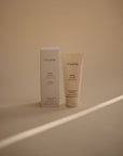 Mushie Baby Cream tube and box on beige background, ideal for soothing dry skin.
