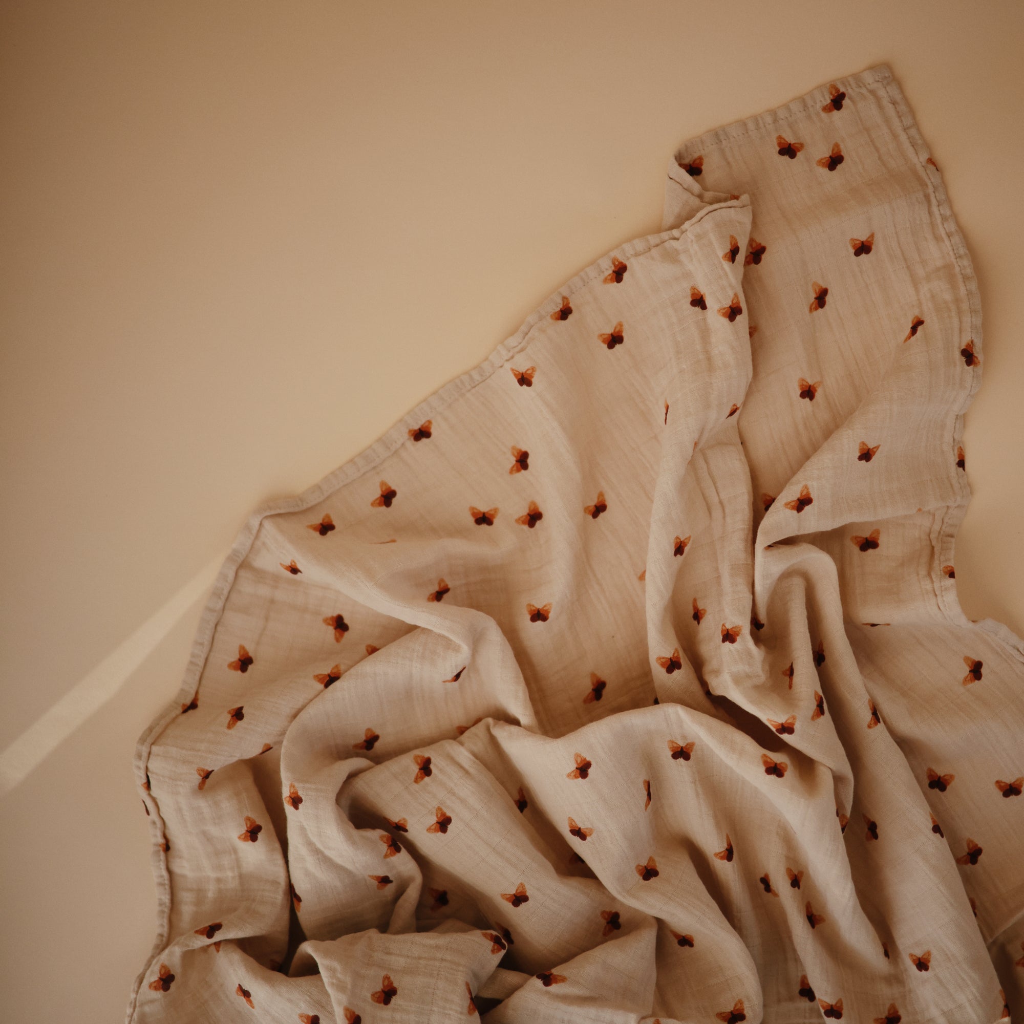Lifestyle image of Organic Cotton Swaddle in Butterflies