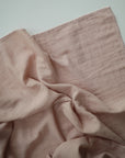 Lifestyle image of Organic Cotton Swaddle in Blush