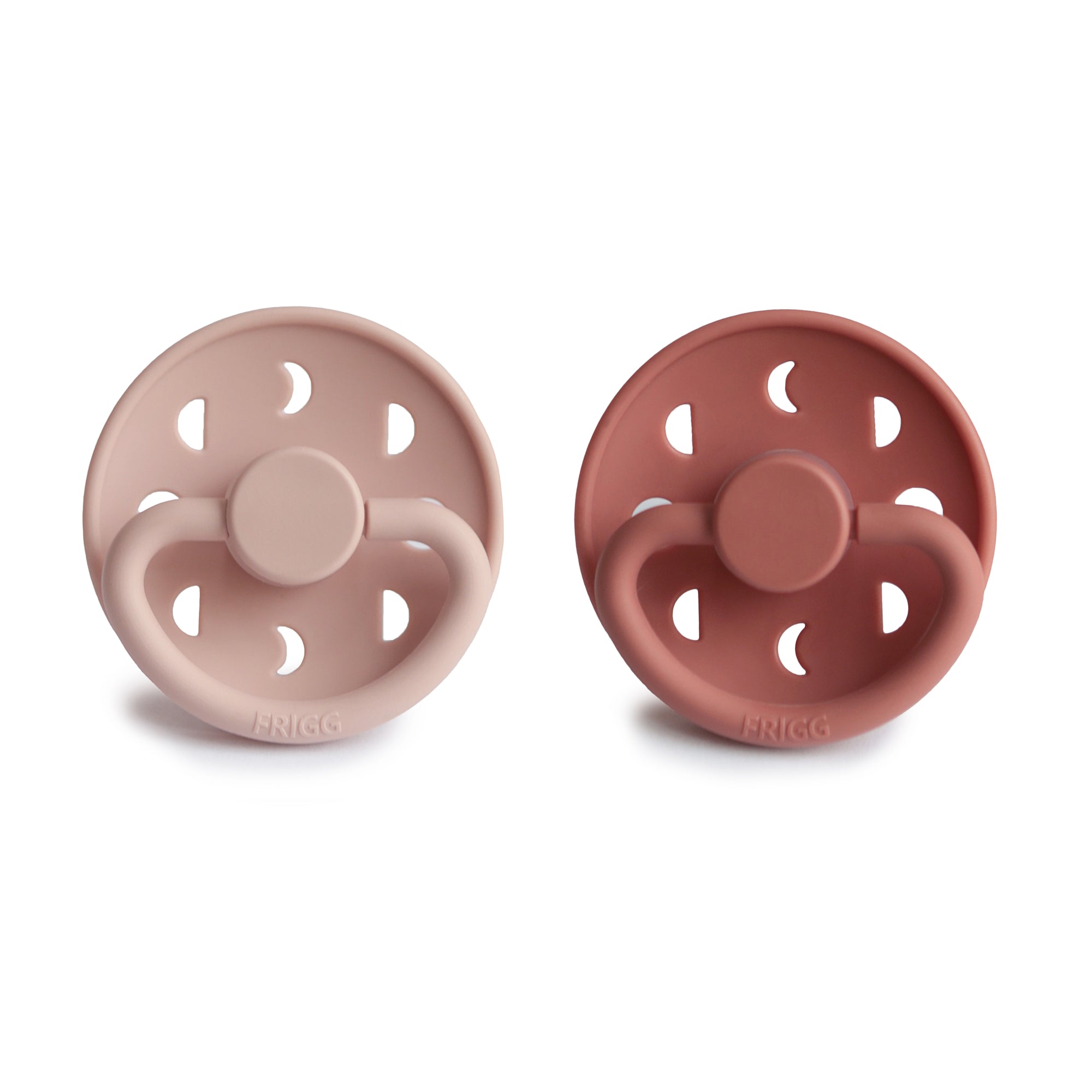 Front view of Blush and Powder Blush Moon Silicone Frigg pacifiers.