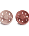 Front view of Blush and Powder Blush Moon Silicone Frigg pacifiers.