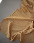 Lifestyle image of Organic Cotton Swaddle in Fall Yellow