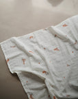 Lifestyle image of Organic Cotton Swaddle in Flowers
