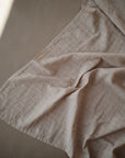 Lifestyle image of Organic Cotton Swaddle in Caramel Polka Dot