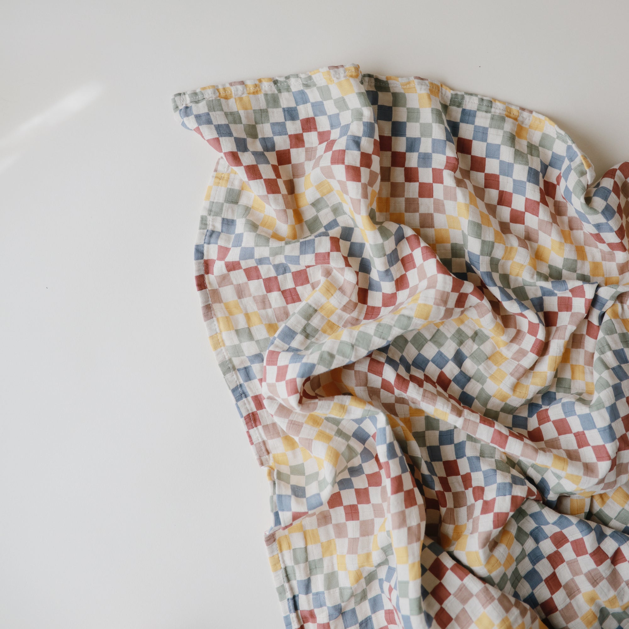 Lifestyle image of Organic Cotton Swaddle in Retro Check