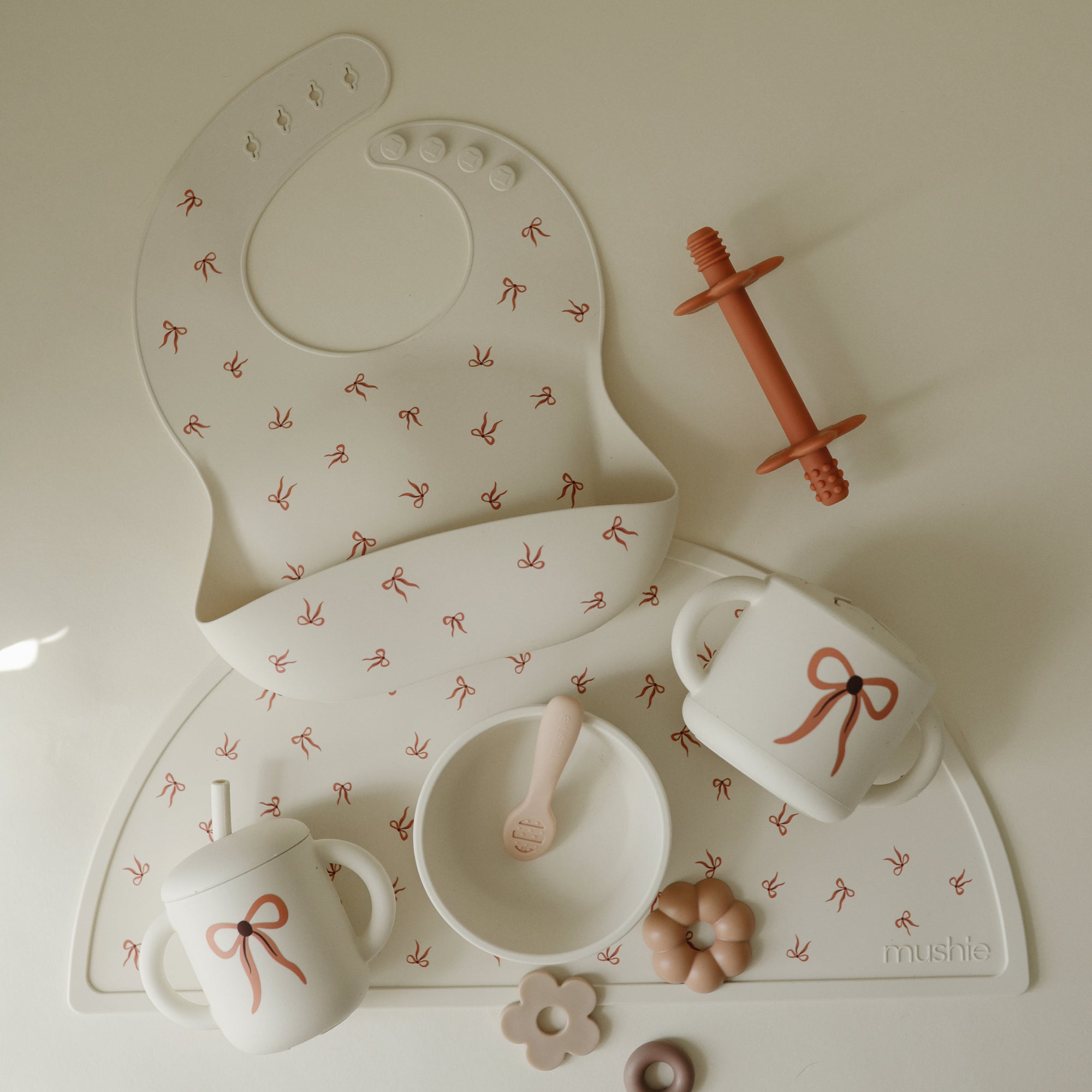 Mushie Silicone Training Cup + Straw included in the baby feeding set with bib and more.