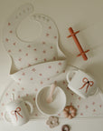 Mushie Silicone Training Cup + Straw included in the baby feeding set with bib and more.