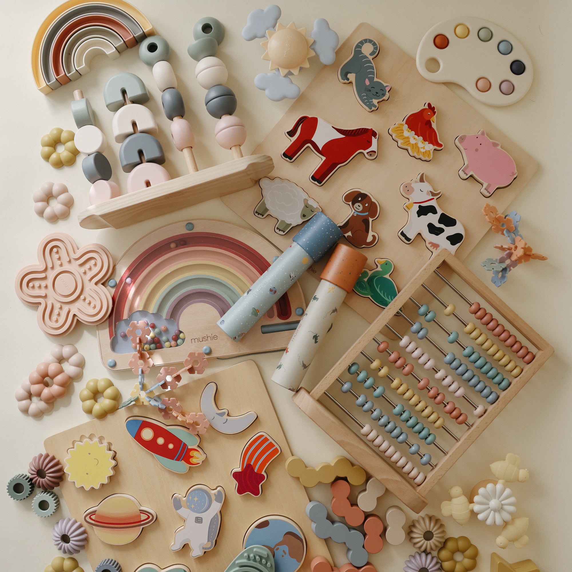 Mushie Kaleidoscopes inspire imaginative play on a light surface.