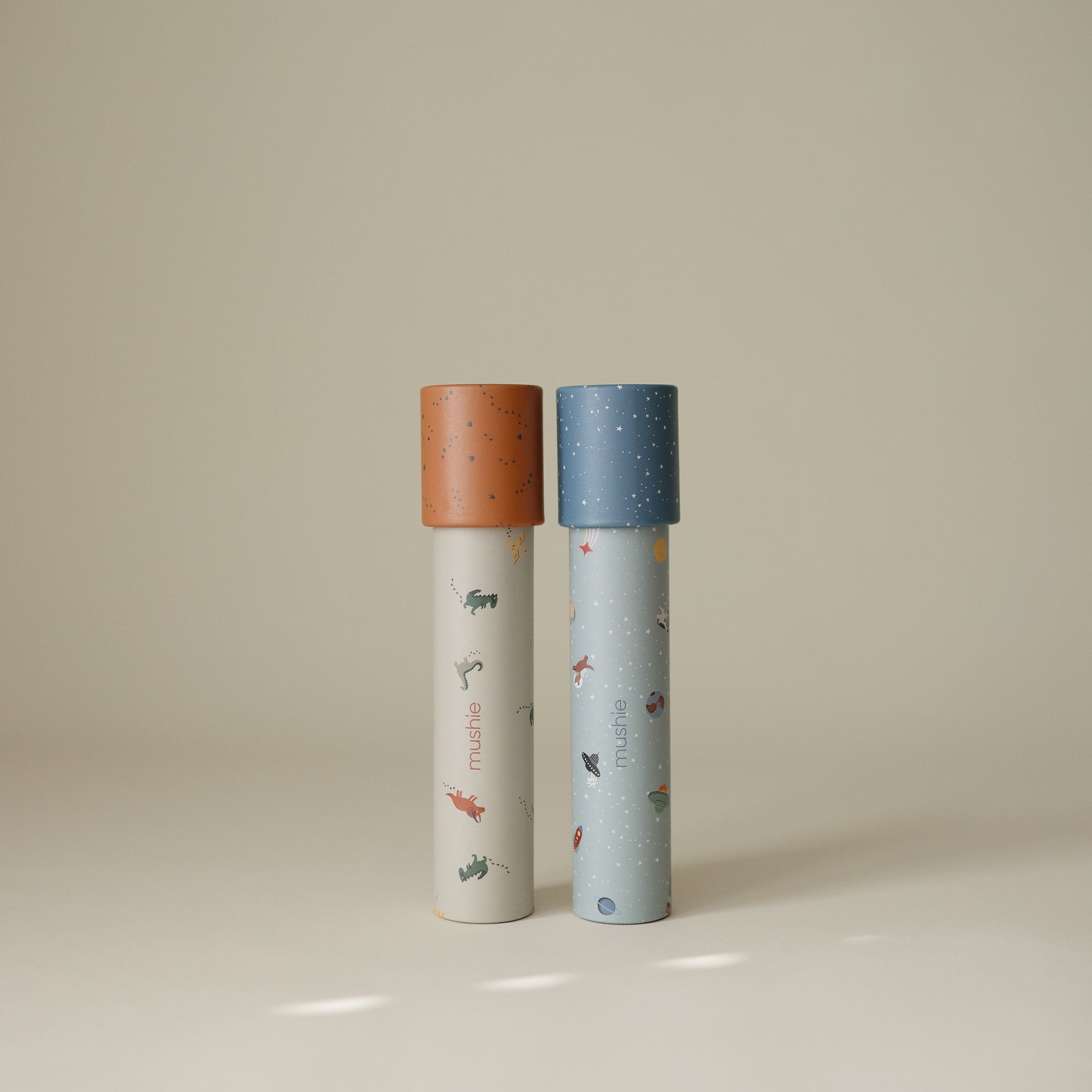 Two mushie Kaleidoscopes for kids, ideal for imaginative play on a neutral background.